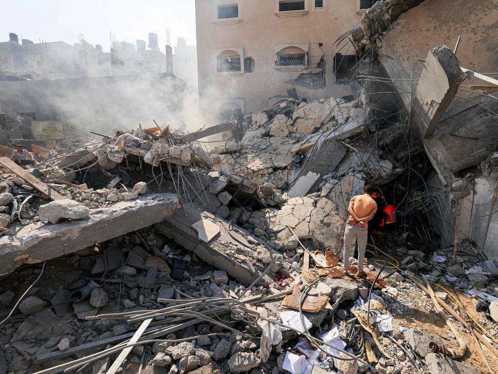 Palestinians look for survivors from under the rubble of a collapsed building following an Israeli strike, in Khan Yunis in the southern Gaza Strip. Picture: AFP