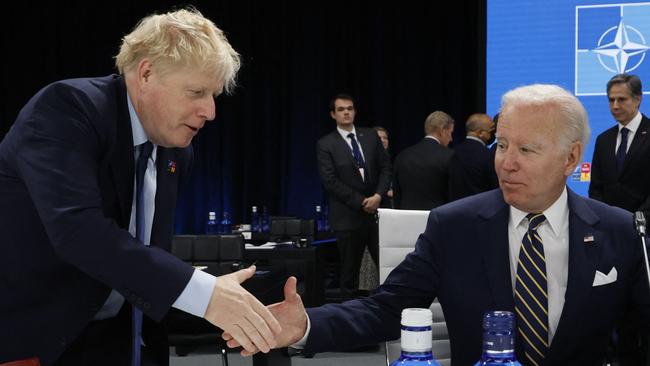 Joe Biden and Boris Johnson shake hands ahead of a meeting of The North Atlantic Council during the NATO summit. Picture AFP.