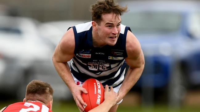 Brodie Hoyne of Macedon is tackled during the round 16 Riddell District Football Netball League 2023 Bendigo Bank Seniors match between Romsey and Macedon at Romsey Park in Romsey, Victoria on August 5, 2023. (Photo by Josh Chadwick)