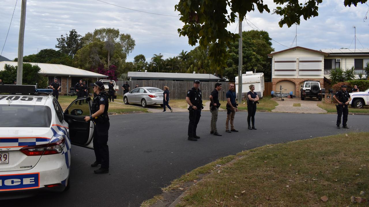 Police standing guard at the home in Norman Gardens as the crowd refused to leave.