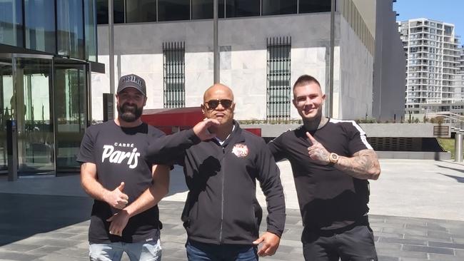 Comancheros Canberra president Pitasoni Ulavalu (centre) celebrates his acquittal on an affray charge outside the ACT Magistrates Court with gang nominee Jaymie Turner (left) and Zachary Robb (right).