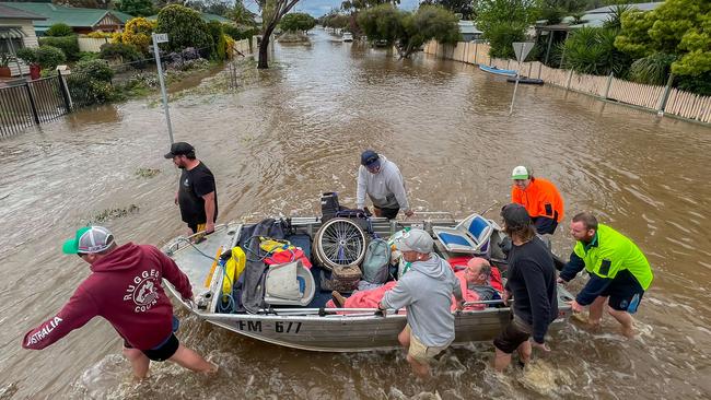 SES moving residents to safety as floodwaters rise around homes in Rochester last October. Picture: Jason Edwards