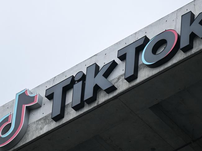 (FILES) This file photo taken on March 16, 2023 shows the TikTok logo displayed on signage outside TikTok's social media app company office in Culver City, California. - Beijing said on March 24, 2023, that it does not ask companies to hand over data gathered overseas, as the Chinese-owned TikTok faces mounting pressure and calls for a ban in the United States. (Photo by Patrick T. Fallon / AFP)