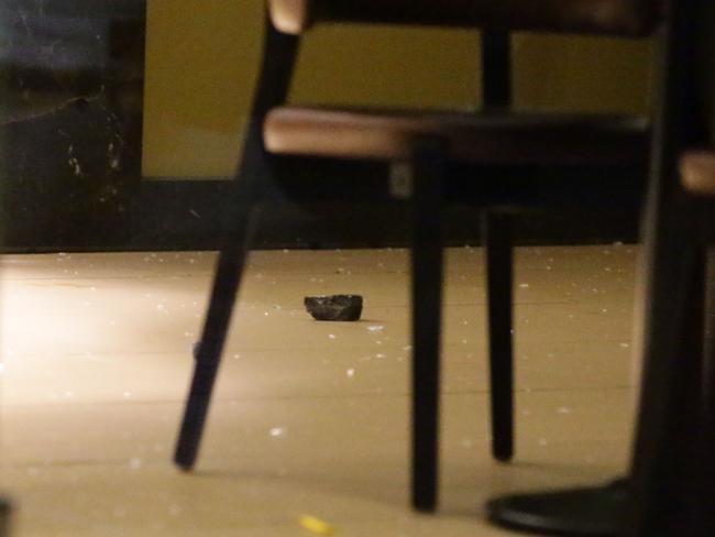 Broken glass and rocks were visible inside the store. Picture: Bill Hearne