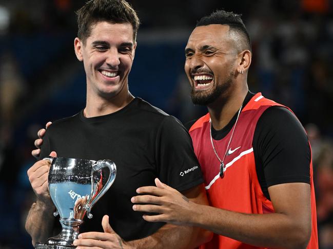 MELBOURNE, AUSTRALIA - JANUARY 29: Thanasi Kokkinakis (L) of Australia and Nick Kyrgios of Australia pose with the championship trophy after winning their Men's DoublesÃÂ Final match against Matthew Ebden of Australia and Max Purcell of Australia during day 13 of the 2022 Australian Open at Melbourne Park on January 29, 2022 in Melbourne, Australia. (Photo by Quinn Rooney/Getty Images)