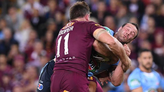 Maroons forward Gavin Cooper stops Blues skipper Boyd Cordner.