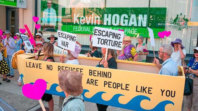 Lismore City Councillor Eddie Lloyd (with microphone) joins refugee advocates and other members of Council in a vigil outside MP Kevin Hogan's office. Picture: Courtesy of R Poole