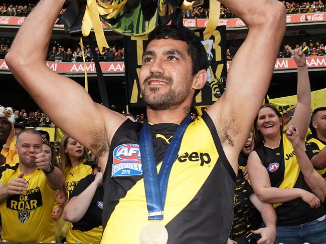 Marlion Pickett of the Tigers celebrates the win with the Premiership Cup during the 2019 AFL Grand Final between the Richmond Tigers and the GWS Giants at the MCG in Melbourne, Saturday, September 28, 2019. (AAP Image/Michael Dodge) NO ARCHIVING