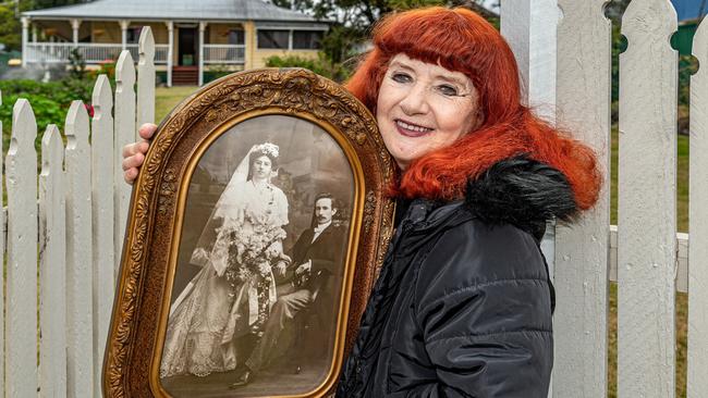 Twelfth Night Theatre owner, Gail Wiltshire, holding the wedding photo of Emmanuel Raymond and Lucy Cossart. Picture: Lyle Radford, The Fassifern Guardian