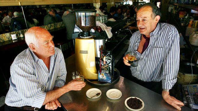 Terrorism victim Sisto Malaspina, right, and co-owner  Nino Pangrazio at their Pellegrini's cafe in Melbourne in 2010. Picture: Aaron Francis