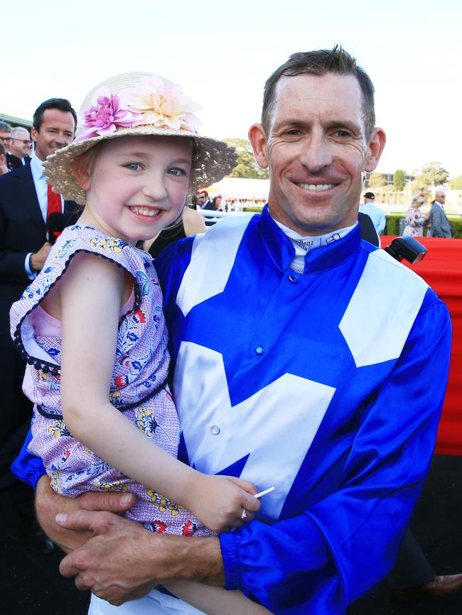 Hugh Bowman with daughter Bambi after another Winx blitz. Pictures: Getty Images, AAP