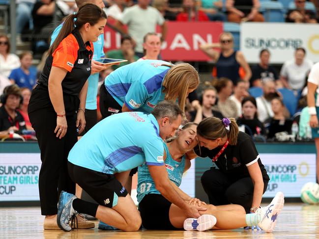 Lauren Moore of the Mavericks receives treatment after going down clutching her knee on Sunday. Picture: Mark Metcalfe/Getty Images for Netball Australia.