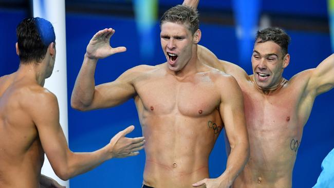 Jake Packard (centre) was part of the gold medal-winning 4x100 medley relay team. Picture: AAP Image/Darren England