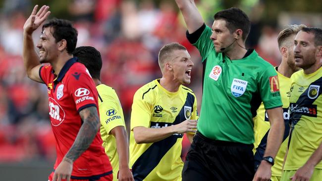 Ersan Gulum of United receives a red card for a tackle on Trent Buhagiar.