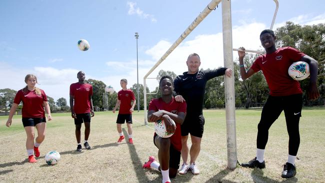 Underdale High School’s Musa Toure, 14, (l) next to PE teacher Josh Hilditch, Adelaide United's Mohamed Toure, 15, with students Mia Kasperski 15, Chicco Nyirenda 16, and Alex Tsimopoulos, 16. Photo Kelly Barnes