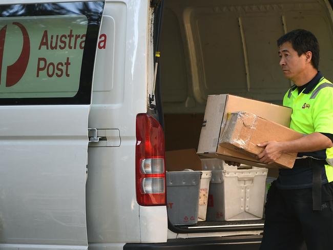 SYDNEY, AUSTRALIA - NCA NewsWire Photos OCTOBER, 01, 2020: An Australia Post worker unloads packages at the Australia Post outlet in Surry Hills. Picture: NCA NewsWire/Joel Carrett