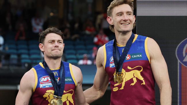 Brisbane Lions captains Lachie Neale and Harris Andrews together on the dais after winning the 2024 AFL Premiership. Picture Lachie Millard