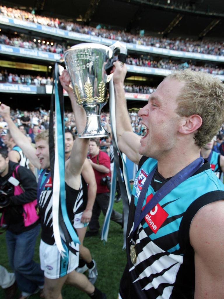 Kane and Chad Cornes lift the 2004 Premiership Cup.