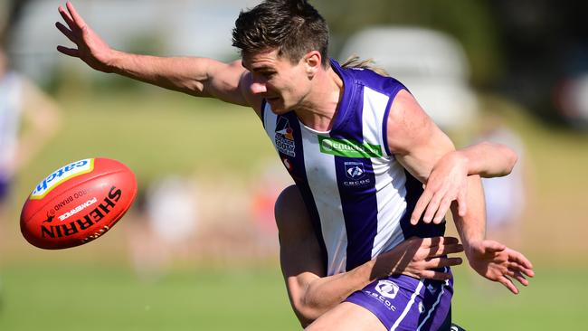 Jake Johansen of CBC Old Collegians is tackled during the Adelaide Footy League division four grand final in September. Picture: AAP/Mark Brake