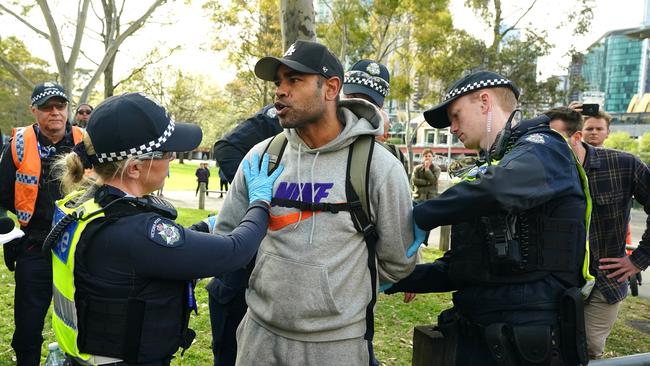 Police move on a protester at the Land Forces rally in Melbourne. Picture: NewsWire / Luis Enrique Ascui