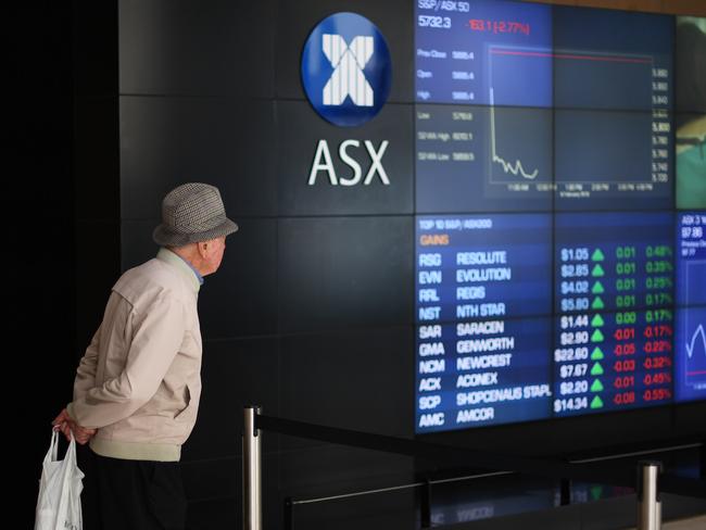 An elderly man looks at the market trading boards on show at the Australian Securities Exchange yesterday. Picture: AAP Image/David Moir