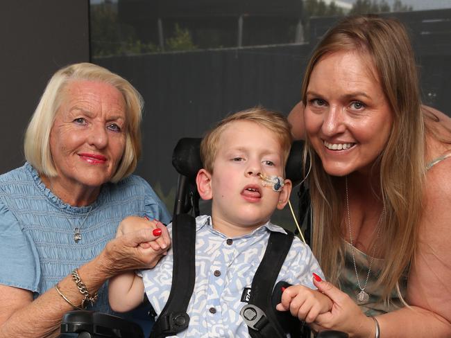 Landon Otsen with Grandma Lynne and mum Lisa. A Torquay family is celebrating after a community effort has raised more than $60,000 for the purchase a special van for their wheelchair bound boy Landon Otsen. Picture: Alan Barber