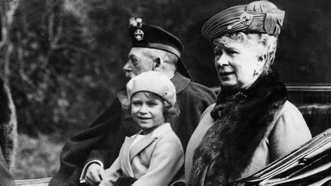 Princess Elizabeth sitting in a horse drawn carriage with her grandparents King George V and Queen Mary on the way back to Balmoral after attending church at nearby Crathie in 1932. Picture: Getty Images.