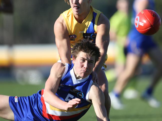 TAC Cup: Eastern Ranges v Western Jets.55 Chayce Black handballs for the  Eastern Ranges.Picture: Stuart Milligan