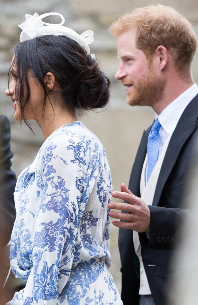 Harry puts a steadying hand on Meghan’s back. Picture: Geoff Robinson Photography/Splash News