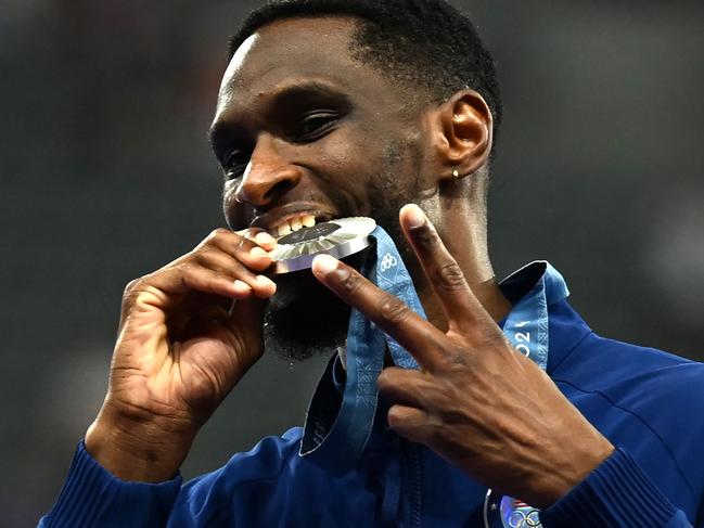 TOPSHOT - Silver medallist US' Shelby McEwen celebrates on the podium after competing in the men's high jump final of the athletics event during the Paris 2024 Olympic Games at Stade de France in Saint-Denis, north of Paris, on August 10, 2024. (Photo by MARTIN BERNETTI / AFP)