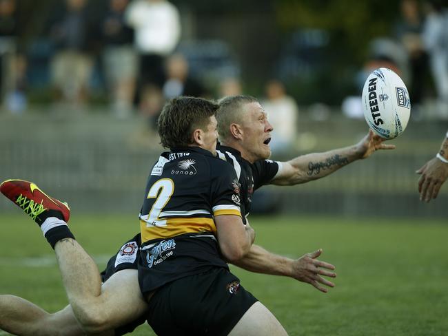 Redfern's Jay Belgrove gets the ball away for the try that clenched the match for Redfern. Picture: John Appleyard