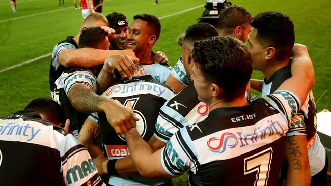 Cronulla players swamp James Maloney after he scored his second try against the Cowboys. Picture: Gregg Porteous