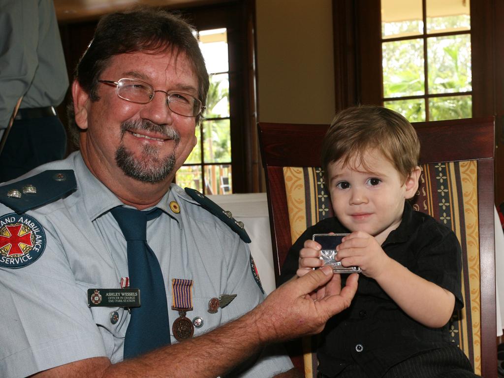 Emu Park ambulance officer Ashley Wessels shows grandson William Wessels his long service medal, presented at the QAS awards at Kershaw House, Rockhampton. Photo: Sharyn O'Neill