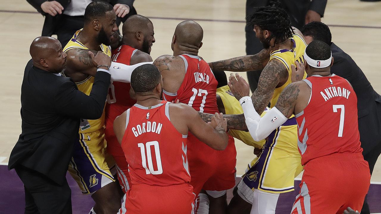 Houston Rockets' Chris Paul, second from left, is held back by Los Angeles Lakers' LeBron James, left, as Paul fights with Lakers' Rajon Rondo, centre obscured. (AP Photo/Marcio Jose Sanchez)