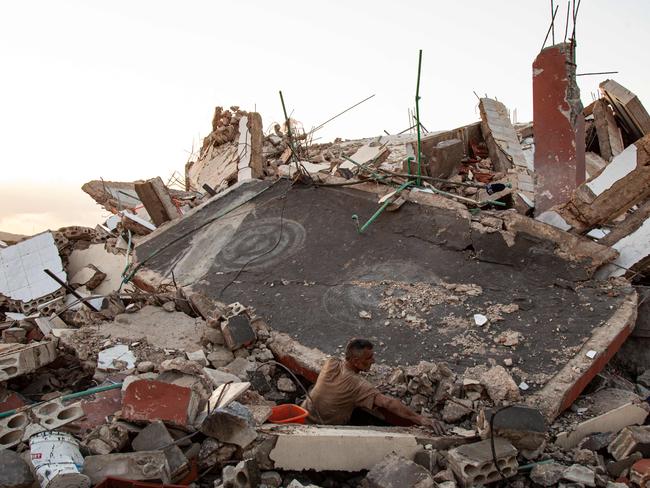 A man checks the ruins of a house after an Israeli air raid in Majdal Zoun as fighting continued with Hamas militants in the southern Gaza Strip. Picture: AFP