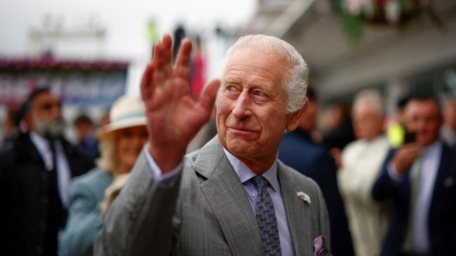 King Charles III waves to the public at Epsom in May.