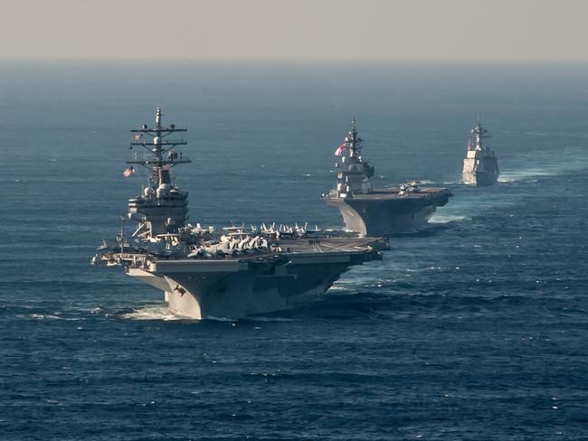 The US Navy's forward-deployed aircraft carrier USS Ronald Reagan (CVN 76) transits alongside Japan Maritime Self-Defense Force (JMSDF) Izumo-class helicopter destroyer JS Izumo (DDH 183) and JMSDF Akizuki-class destroyer JS Teruzuki (DD 116). Picture: USN