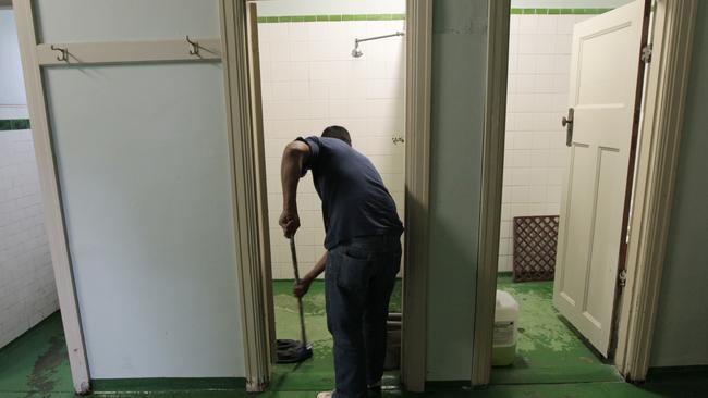 Adrian cleans one of the bathrooms inside the Gatwick Hotel which has been sold and will close its doors in 2017.