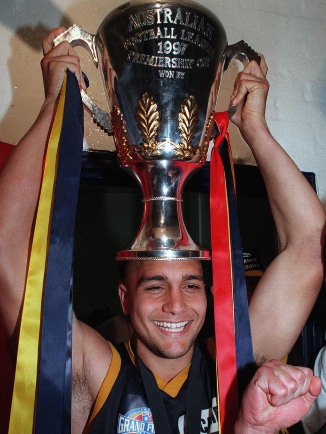 Andrew McLeod holds the 1997 AFL premiership cup aloft after producing a dazzling, Norm Smith Medal-winning performance for Adelaide against St Kilda. Picture: Craig Borrow