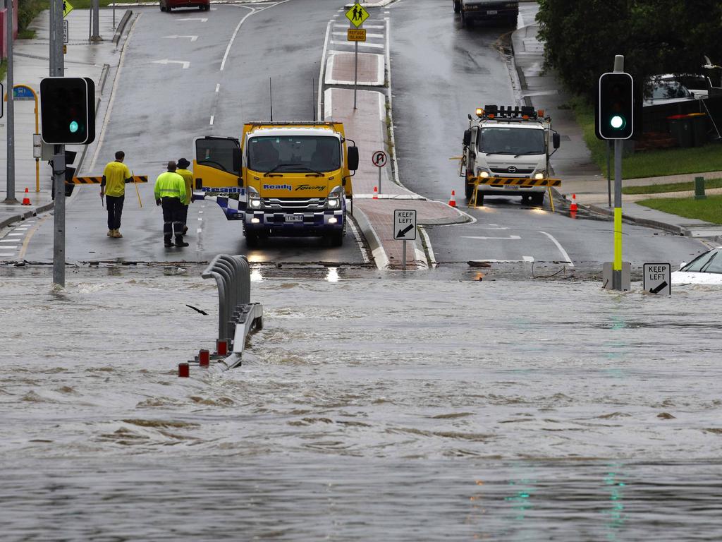 A car is stuck in flood waters in Toombul after heavy rain fell overnight in Brisbane. Picture: Tertius Pickard