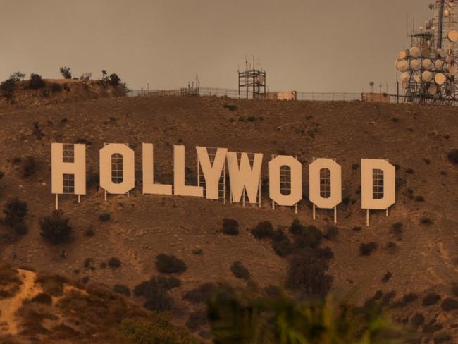 HOLLYWOOD, CA - JANUARY 08: The Hollywood Sign is seen with smoke from multiple wildfires on January 08, 2025 in Hollywood, California.  (Photo by AaronP/Bauer-Griffin/GC Images)