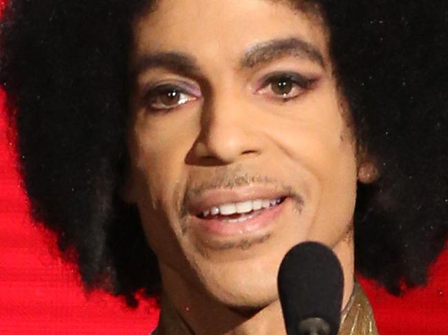 FILE - In this Nov. 22, 2015 file photo, Prince presents the award for favorite album - soul/R&B at the American Music Awards in Los Angeles. Prince, widely acclaimed as one of the most inventive and influential musicians of his era with hits including "Little Red Corvette," ''Let's Go Crazy" and "When Doves Cry," was found dead at his home on Thursday, April 21, 2016, in suburban Minneapolis, according to his publicist. He was 57. (Photo by Matt Sayles/Invision/AP, File)