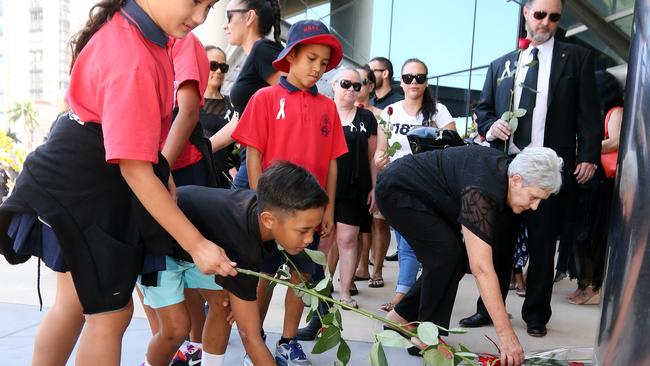 Tara’s boss, lawyer Jason Hall, with family and friends, laying roses outside the courthouse. Pic by Richard Gosling