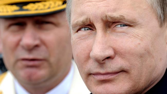 FILE - In this July 26, 2015 file photo, Russian President Vladimir Putin, foreground, reviews a Navy parade in Baltiisk, western Russia. The tide of global rage against the Islamic State group lends greater urgency to ending the jihadis’ ability to operate at will from a base in war-torn Syria. That momentum could also force a reevaluation of what to do about President Bashar Assad’s future and puts a renewed focus on the position of his key patrons, Russia and Iran. (Mikhail Klimentyev/Sputnik, Kremlin Pool Photo via AP, File)