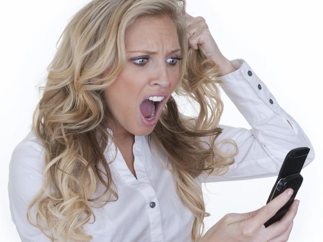 Generic image of smartphone iPhone user. Blonde woman angry at phone.