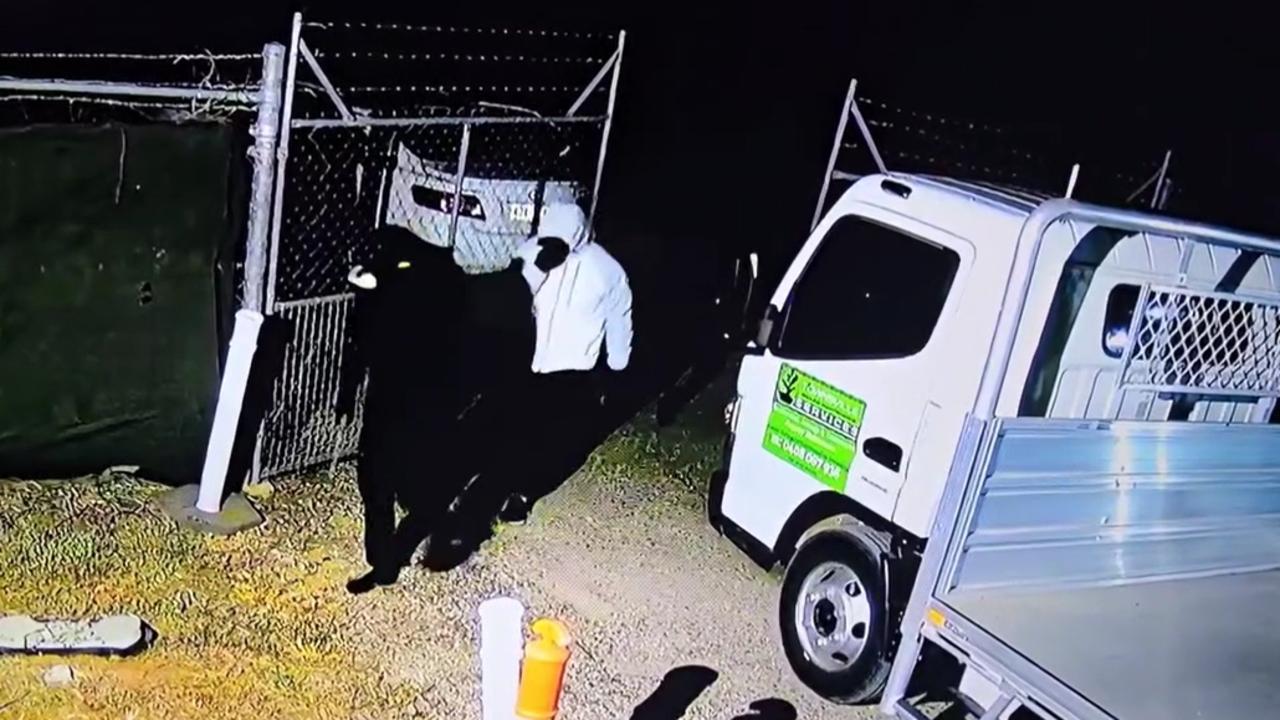 The two men finally enter Townsville and Northern Beaches Trailer Hire after spending almost three minutes trying to work out how to use bolt cutters to cut through a lock and chain.