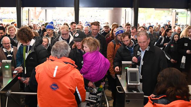 Footy fans enter the MCG for the Cats and the Collingwood showdown.