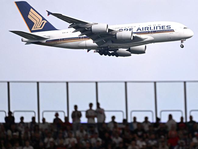 A Singapore Airlines aircraft flies near the Frankfurt Arena during the UEFA Euro 2024 Group E football match between Belgium and Slovakia, in Frankfurt am Main on June 17, 2024. (Photo by Kirill KUDRYAVTSEV / AFP)