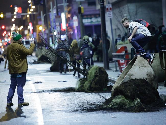 Fans celebrate by kicking over giant pot plants.