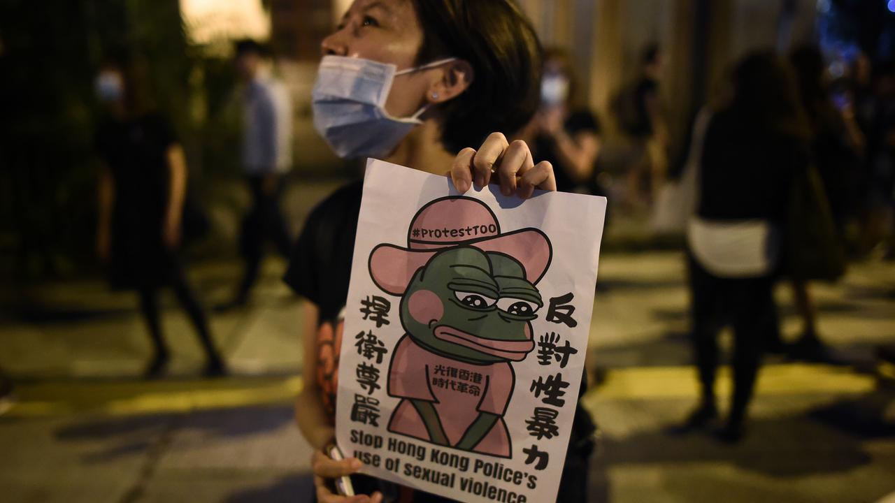 A protester holds a sign at a #MeToo rally in Hong Kong to protest alleged sexual assaults by police against anti-government female protesters. Picture: Lillian Suwanrumpha/AFP